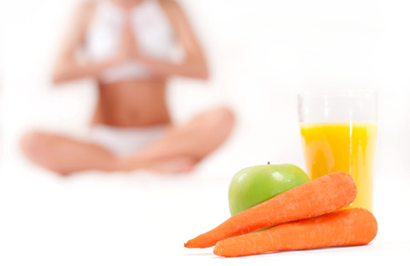 Diet concept. Slim woman. Glass of orange juice with green apple and carrotの写真素材