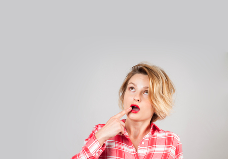 Portrait of business lady looking up. Beautiful thinking woman has ideas or dreamsの写真素材