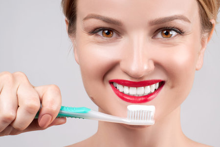 White teeth and red lips. Perfect female smile after bleaching. Dental care and whitening teeth....