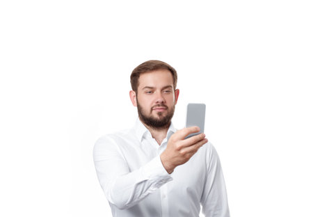 Portrait of business man holding smartphone on white backgroundの写真素材