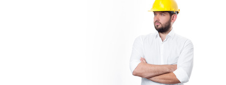 Contractor in yellow helmet on white background. Architect in builder helmet.の写真素材
