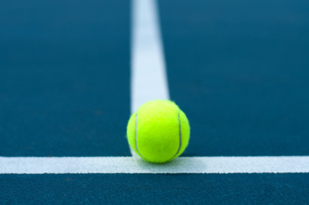 Close-up tennis ball on tennis court with white lineの写真素材