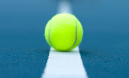 Close-up tennis ball on tennis court with white lineの写真素材