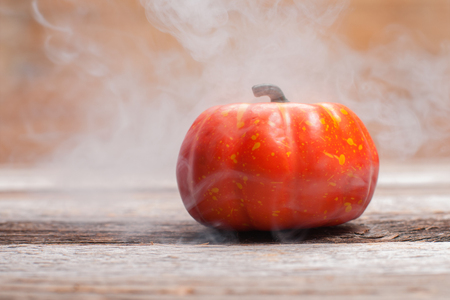 Halloween pumpkin. Autumn background with pumpkin on wooden backgroundの写真素材