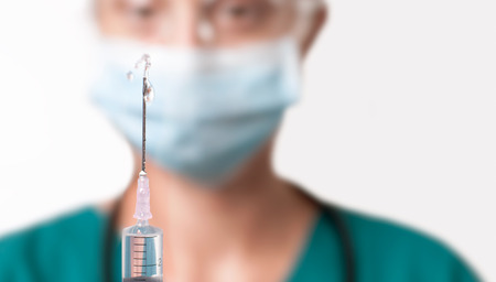 Female doctor with syringe. Nurse or health worker with syringeの写真素材