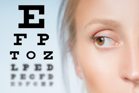 Close up image of an eye and vision test chartの写真素材
