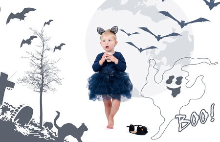 Halloween costume. Little toddler girl dressed for Halloween as black catの写真素材