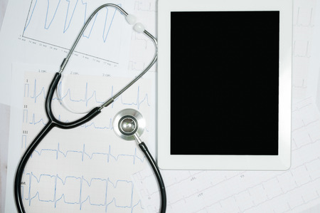 Medical stethoscope with tablet display and cardiogram chart.の写真素材