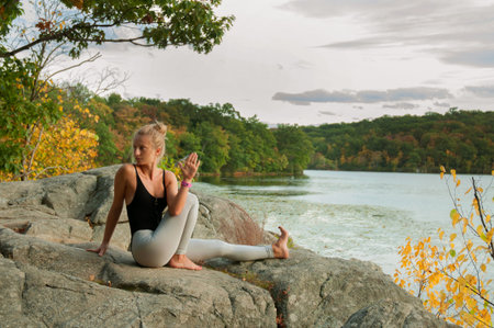 Portrait of beautiful young woman practicing yoga at outside