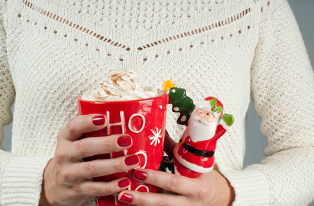  Christmas and happy holiday concept. Close-up of a woman is holding a cup of coffee. の写真素材