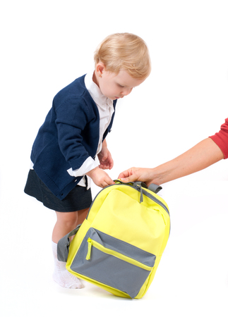 Happy little schoolgirl. Child with backpack and books. Preschool go to school. の写真素材