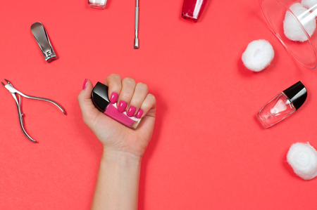 Nail care and manicure. Beautiful female hands with pink nail polishの写真素材