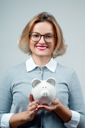 Woman holding piggy bank . Financial budget savings, smart investment conceptの写真素材