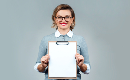 Business woman holding blank paper clipboardの写真素材