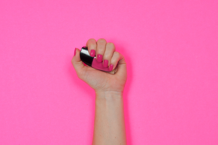 Nail care and manicure. Beautiful female hands with pink nail polishの写真素材