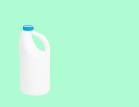 Plastic bottle of household detergent on pastel green background の写真素材