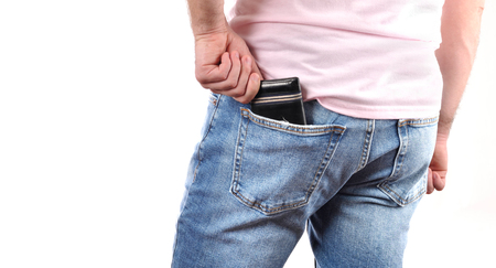 Man put wallet in back pocket of his jeansの写真素材