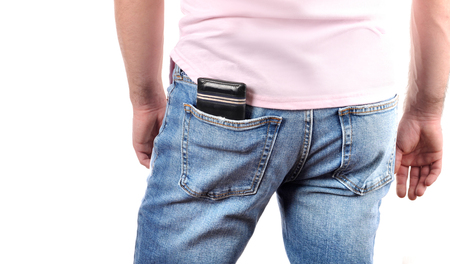 Man put wallet in back pocket of his jeansの写真素材