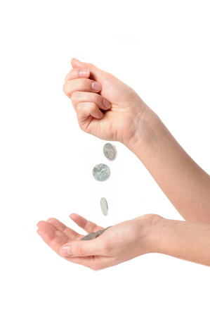 Female hands and falling coins on white background. Coins in palmの写真素材