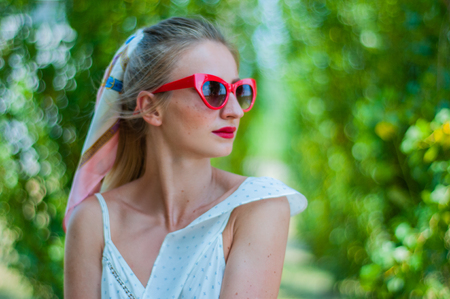 Beautiful happy woman having a rest in the park summer.の写真素材