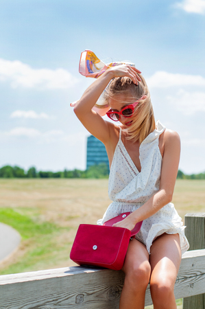 Beautiful happy woman having a rest in the park summer.の写真素材