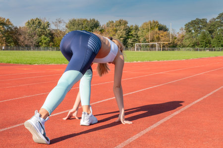 Beautiful woman ready to start running on runway