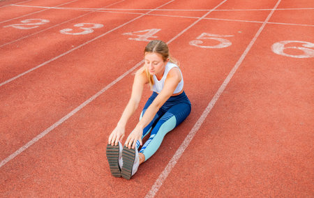 Healthy lifestyle. Fitness woman stretching legs before run on outdoorsの写真素材