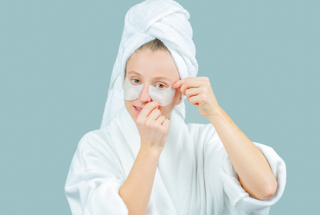 Face care and beauty treatments. Beautiful woman with cosmetic patches under eyesの写真素材