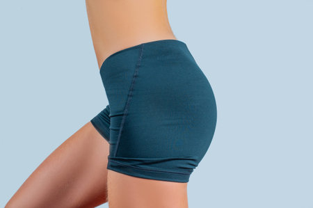 Female bottom in sports shorts. Slim woman body, beautiful woman with perfect buttocks