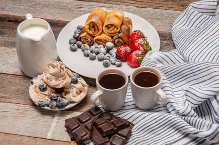 Healthy breakfast, coffee and delicious homemade pancakes with fresh berries on wooden table
