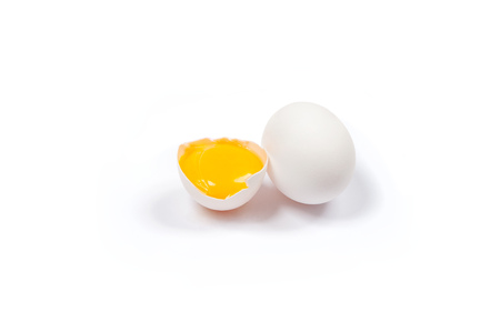 White egg and yolk. Raw eggs on white background. Concept happy easter.の写真素材