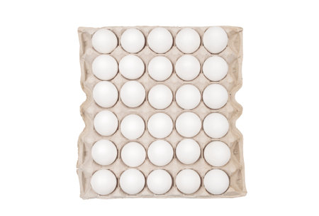 Raw chicken eggs in egg box on white background