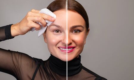 Beautiful woman removing makeup from her face. Skin care and beauty conceptの写真素材