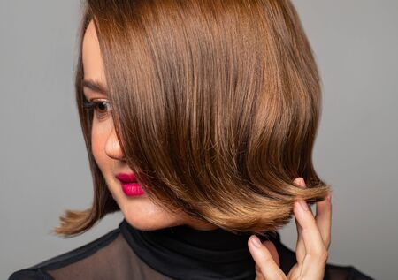 Brunette girl with shiny brown hair. Beautiful woman with bob haircutの写真素材