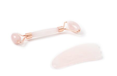 Jade roller for face massage. Jade face roller for beauty facial massage therapy on white backgroundの写真素材