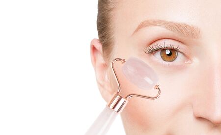 Beautiful female eye. Anti-aging treatment wrinkles under eye with jade roller. Face massage with jaderoller.の写真素材