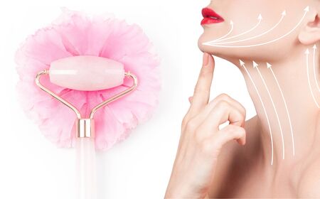 Anti-aging treatment and face lift massage with jade roller. Beautiful woman face and neck after massage.の写真素材