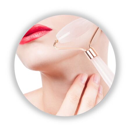 Anti-aging treatment and face lift massage with jade roller. Beautiful woman face and neck after massage.の写真素材