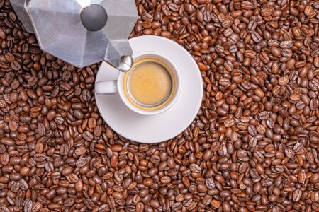 Neapolitan coffee . Cup of hot black coffee on roasted coffee beansの写真素材