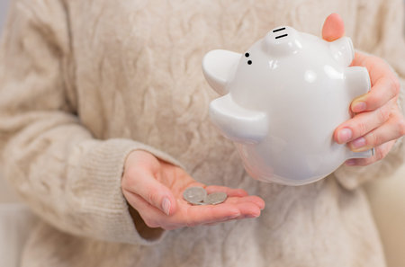 Woman is shaking piggy bank. Financial problem concept