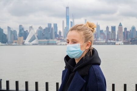 Woman is wearing medical protective mask. Health protection prevention during coronavirus epidemic, infectious diseases and air pollution in the cityの写真素材