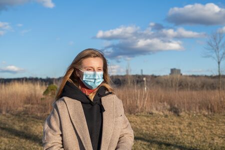 Coronavirus and Air pollution pm2.5 concept. Woman wearing protection mask because of virus epidemic and flu in the cityの写真素材