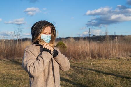 Virus and Air pollution pm2.5 concept. Woman wearing protection mask because of virus epidemic and flu in the cityの写真素材