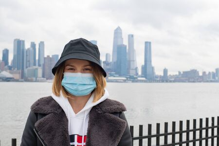 Woman is wearing medical protective mask. Health protection prevention during coronavirus epidemic, infectious diseases and air pollution in the cityの写真素材