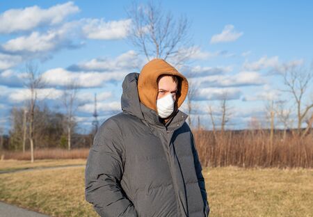 Virus and Air pollution pm2.5 concept. Man wearing protection mask because of virus epidemic and flu in the cityの写真素材