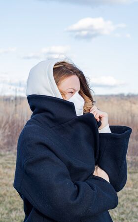 Coronavirus and Air pollution pm2.5 concept. Woman wearing protection mask because of virus epidemic and flu in the cityの写真素材