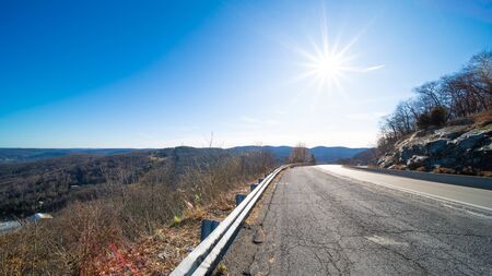Empty highway asphalt road and beautiful sunny sky landscapeの写真素材