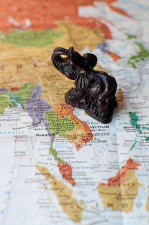 Close-up of Thai Elephant Trinket on Mapの写真素材