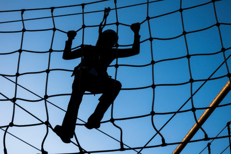Person climbing on high ropesの写真素材