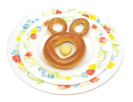 Bagel and dryings on two dishes, symbolic image of bear-cub, with a heart from a thin captain.      ...